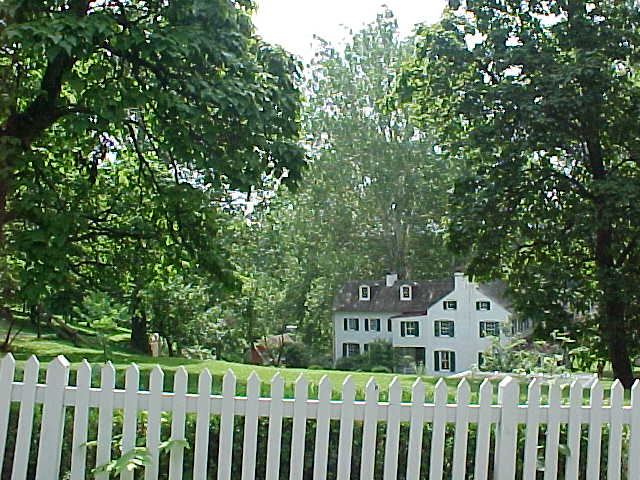 A white house behind a white fence. Standard stuff.