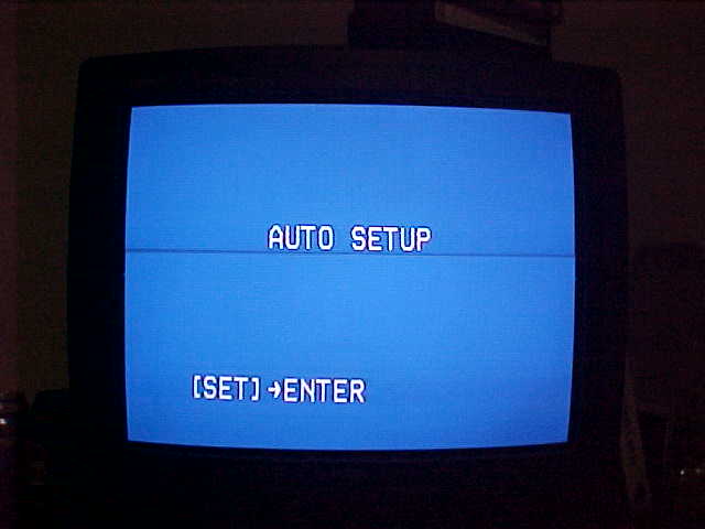 A blue screen with the text readin' AUTO SETUP on it, beamin' right into your eyes with a CRT.
